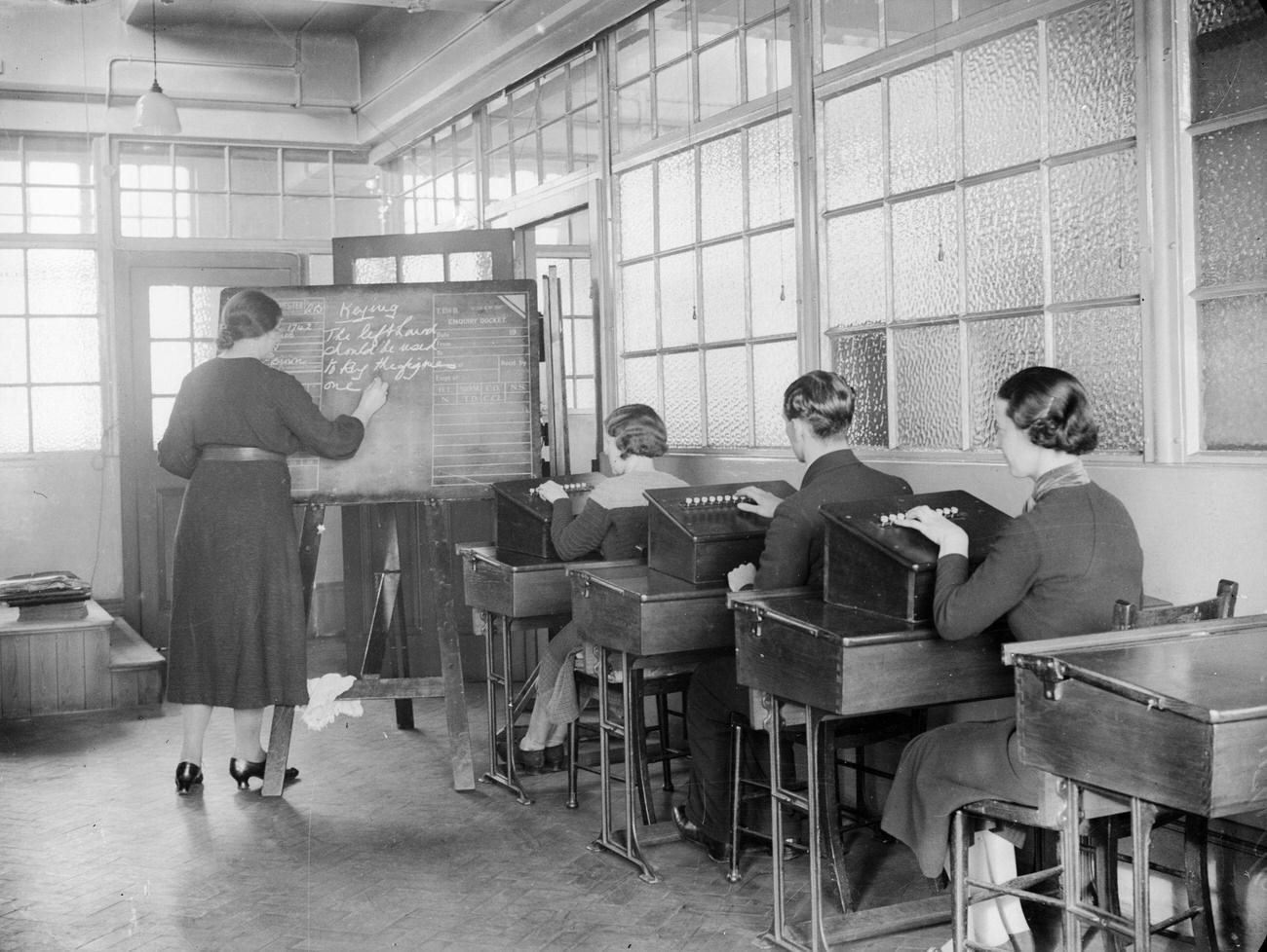 Class learning to key telephone calls to automatic exchanges, Telephone House, Salford, February 1937.