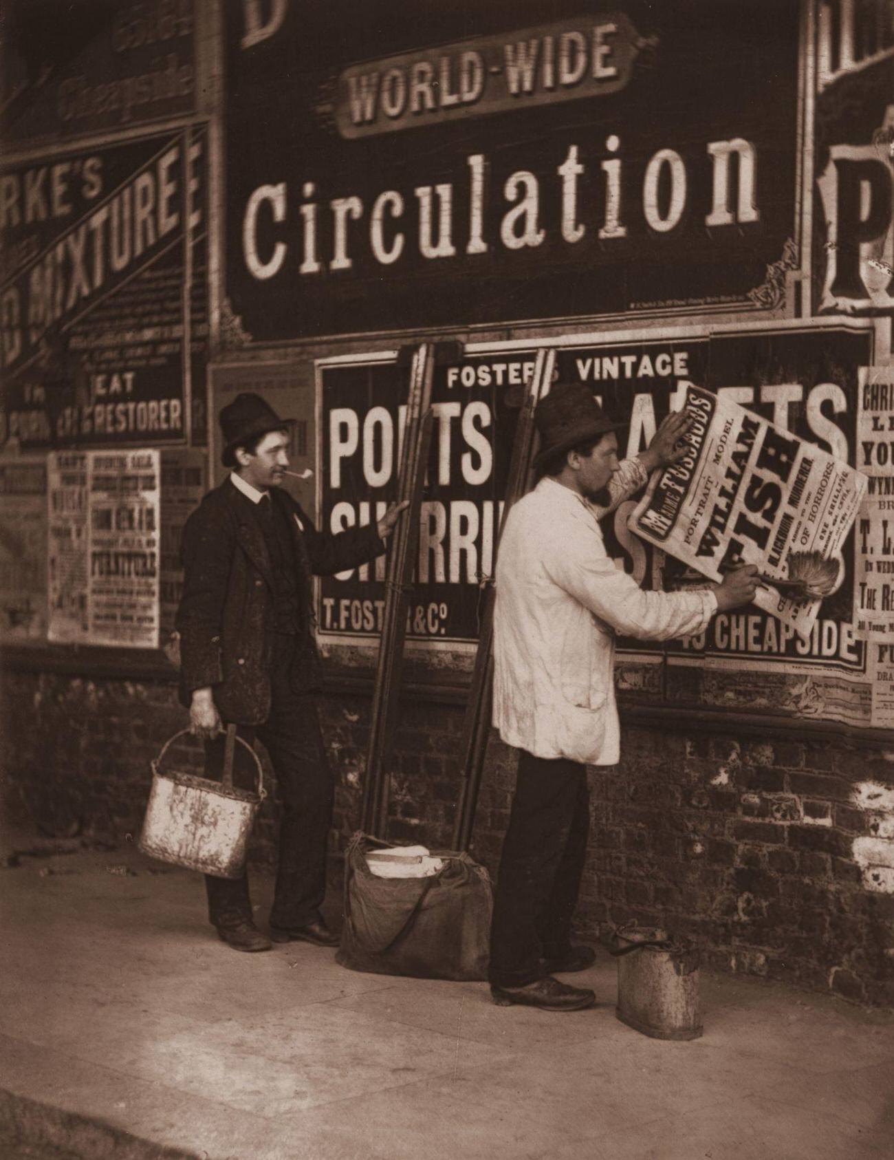 Victorian bill stickers advertising Madame Tussaud's waxworks museum in London, 1877.