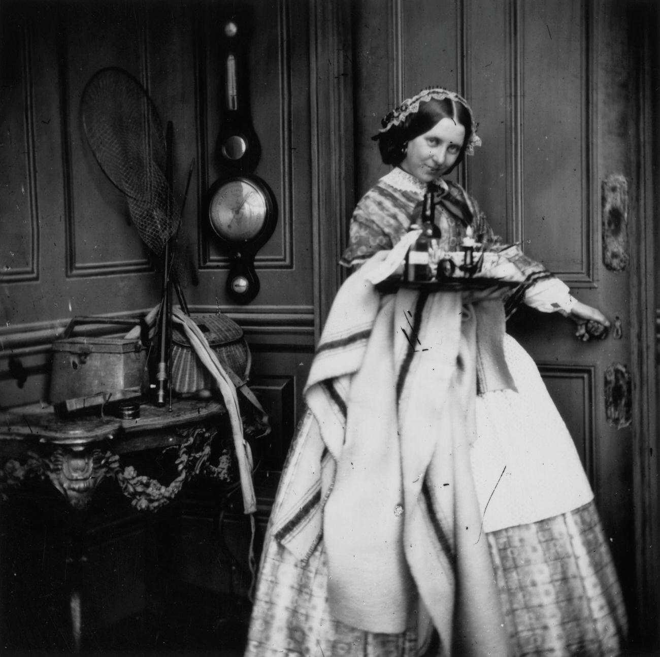 A Victorian servant carrying a tray, circa 1860.