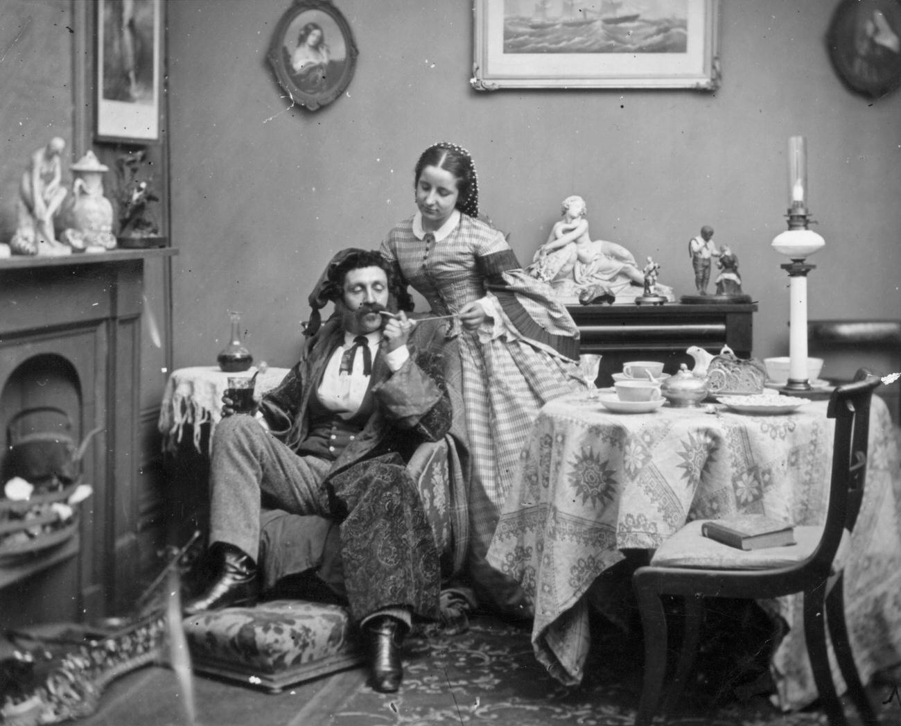 A pampered Victorian husband and his wife, circa 1865.