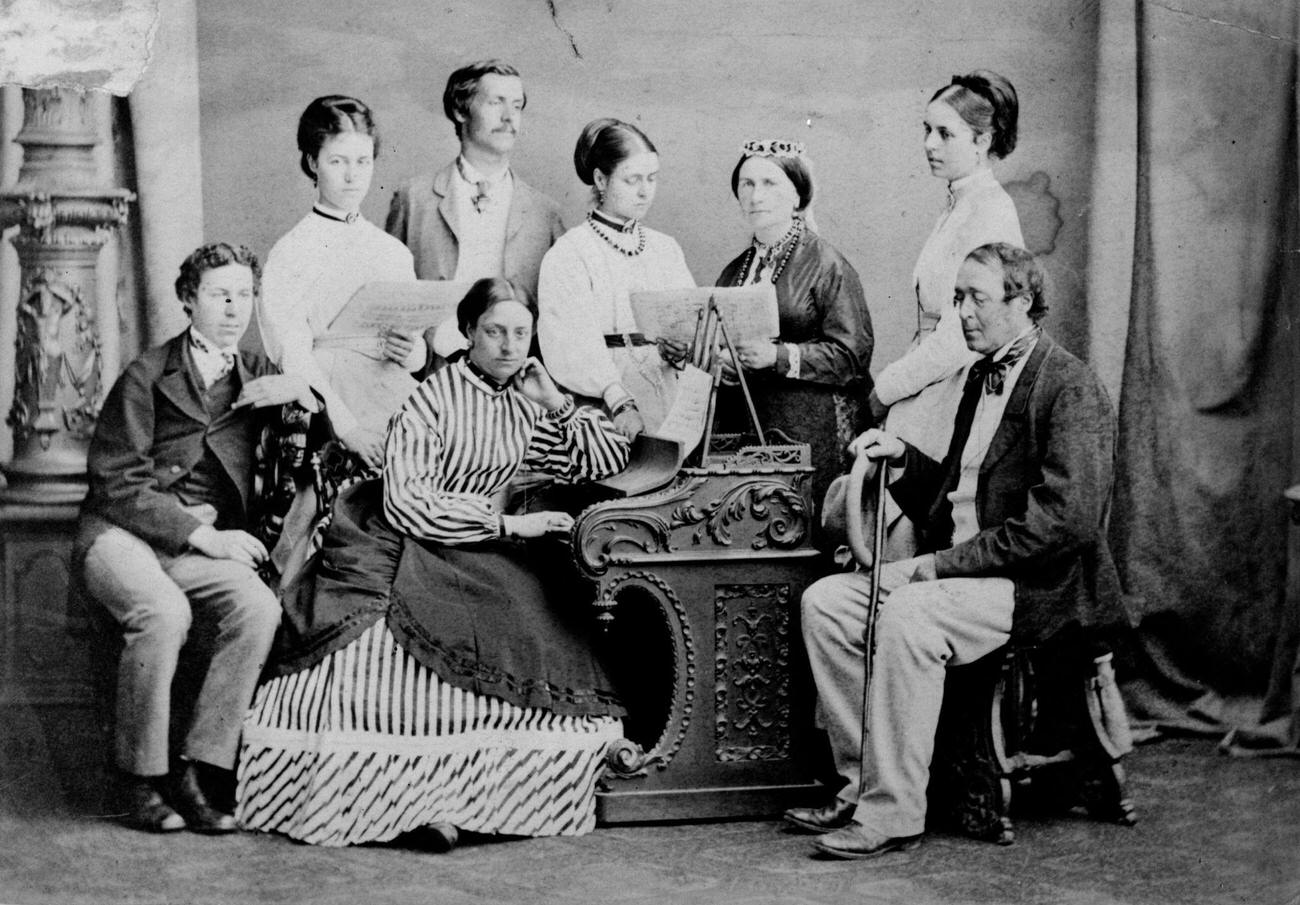 A Victorian family gathered around the piano, circa 1865.