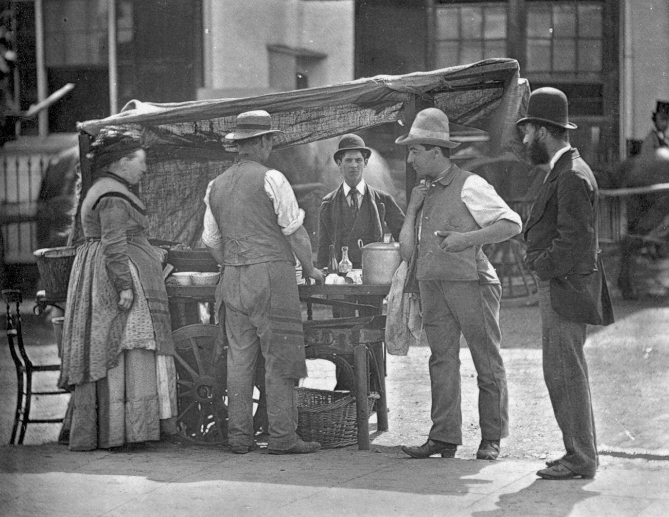 Victorian shellfish stall holder selling oysters and whelks, 1877.