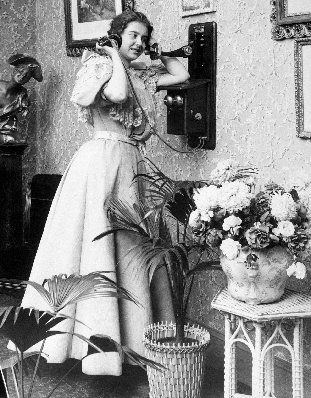 Victorian woman talking on the telephone, 1890.