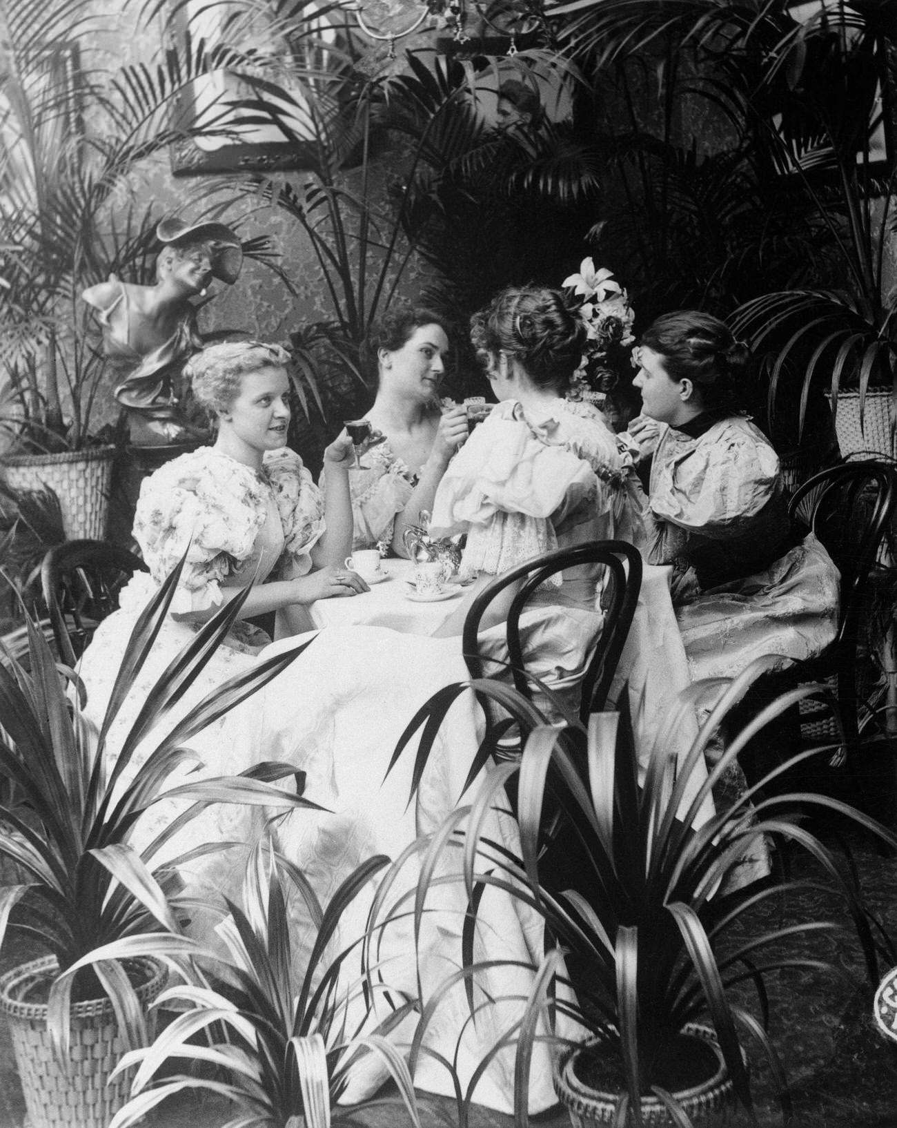 Victorian ladies at a tea party, late 19th century.
