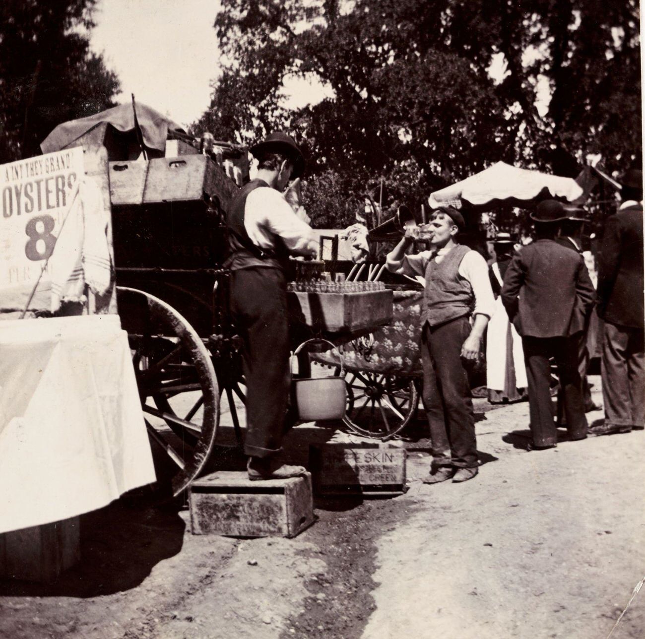 Men at a fairground drinks stall, circa 1898.