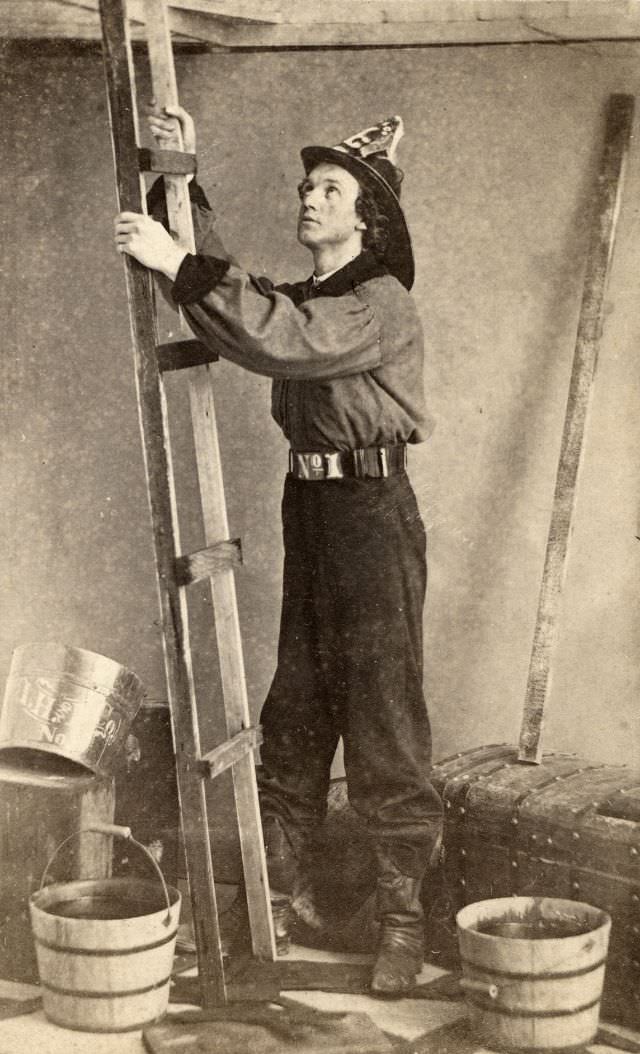 A fireman reenacts a scene as he prepares to climb a ladder