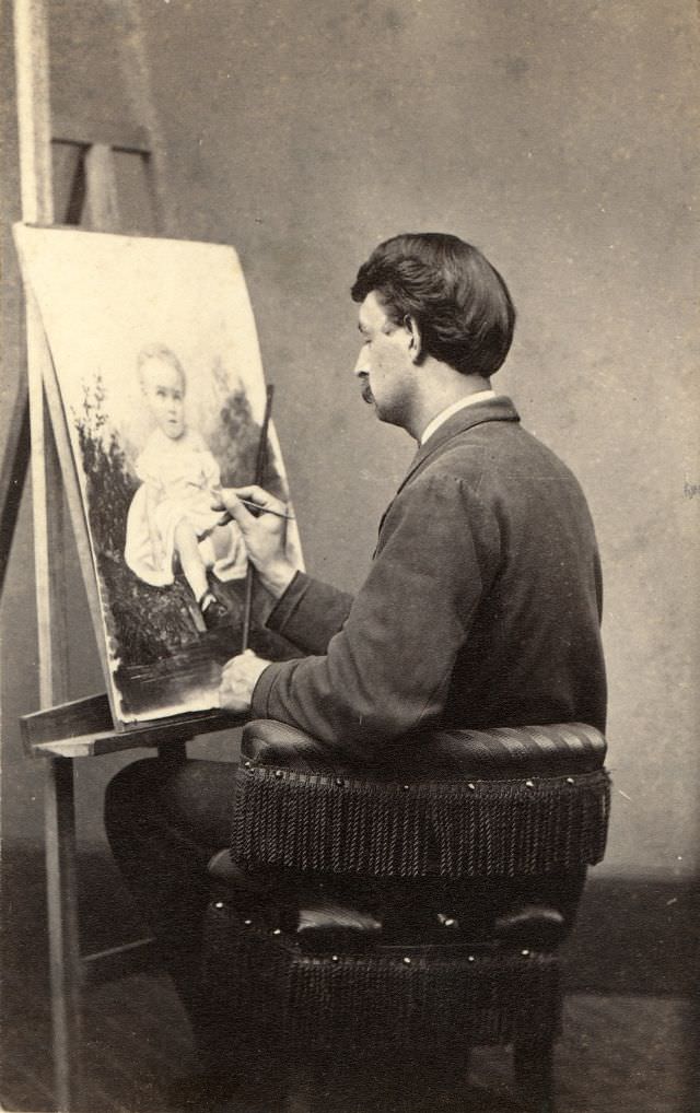 An artist applies his paint brush to artwork depicting a child