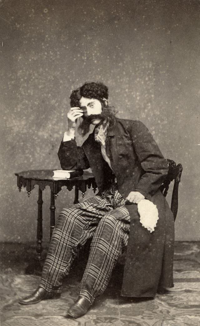 The monocle, fake whiskers, neckerchief, handkerchief and plaid pants worn by this man points to his connection to the theater or a costume party
