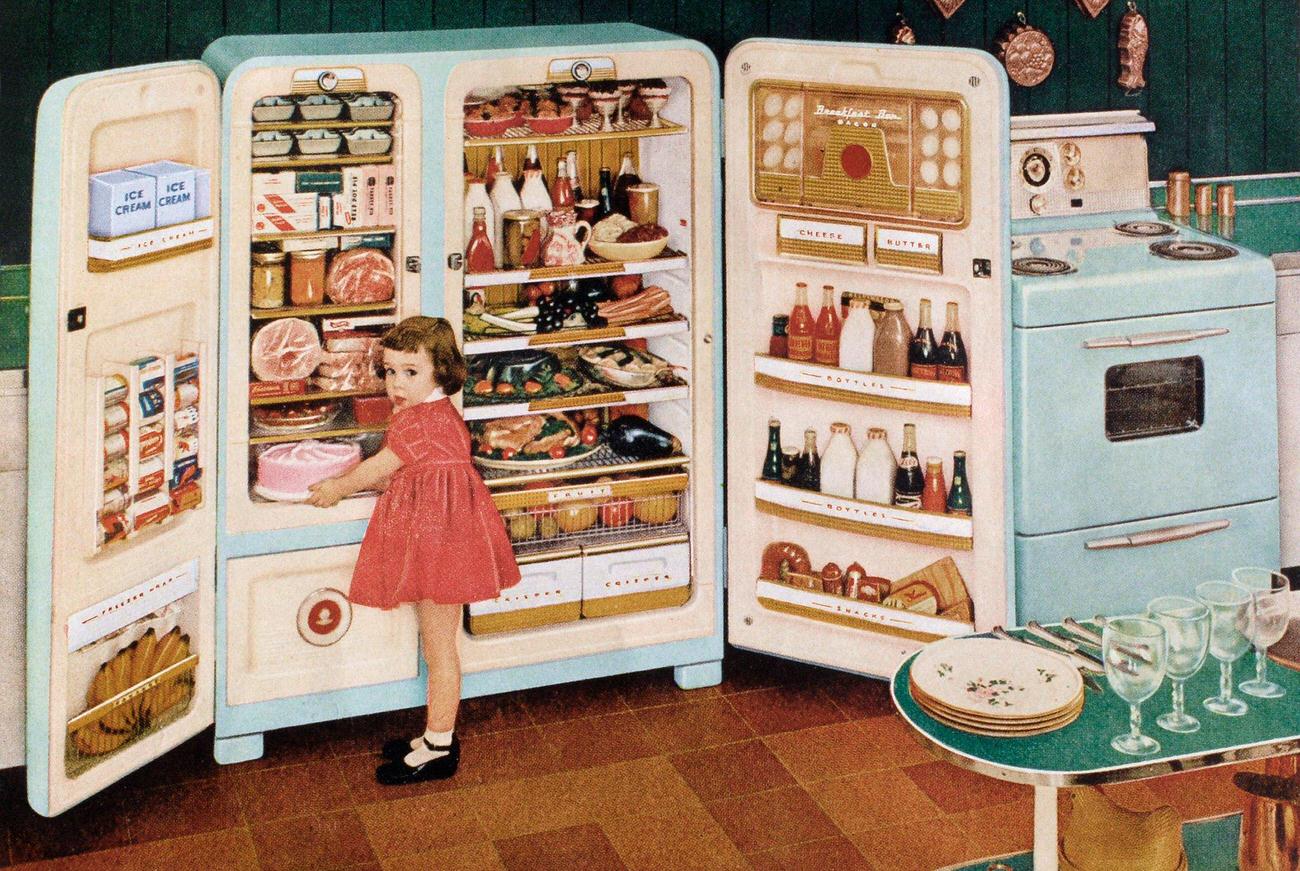 Huge open refrigerator with food and girl, advertisement, 1955.