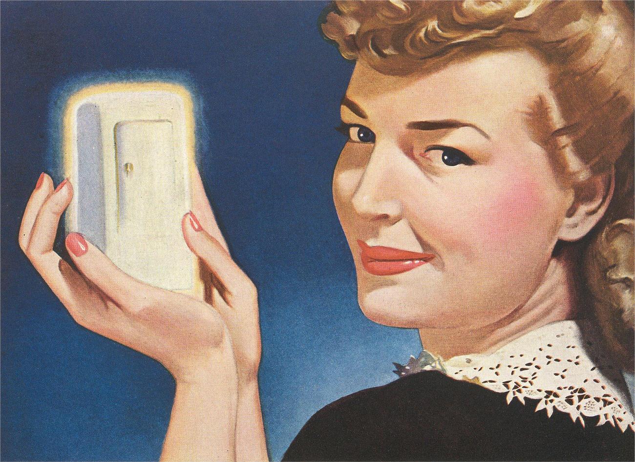 Woman holding miniature fridge, 1940s.