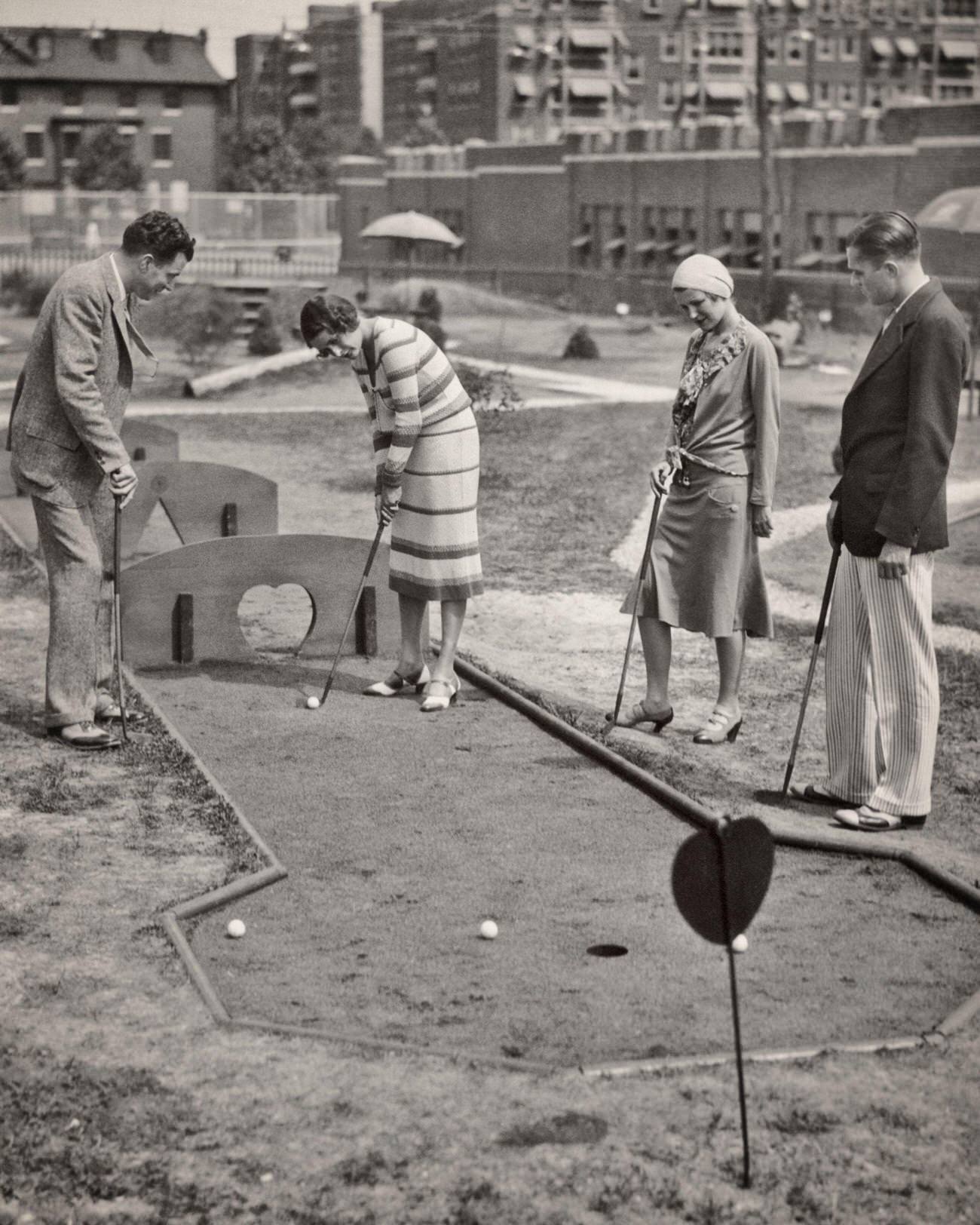 Two couples playing miniature golf, Philadelphia, PA, 1920s-1930s.