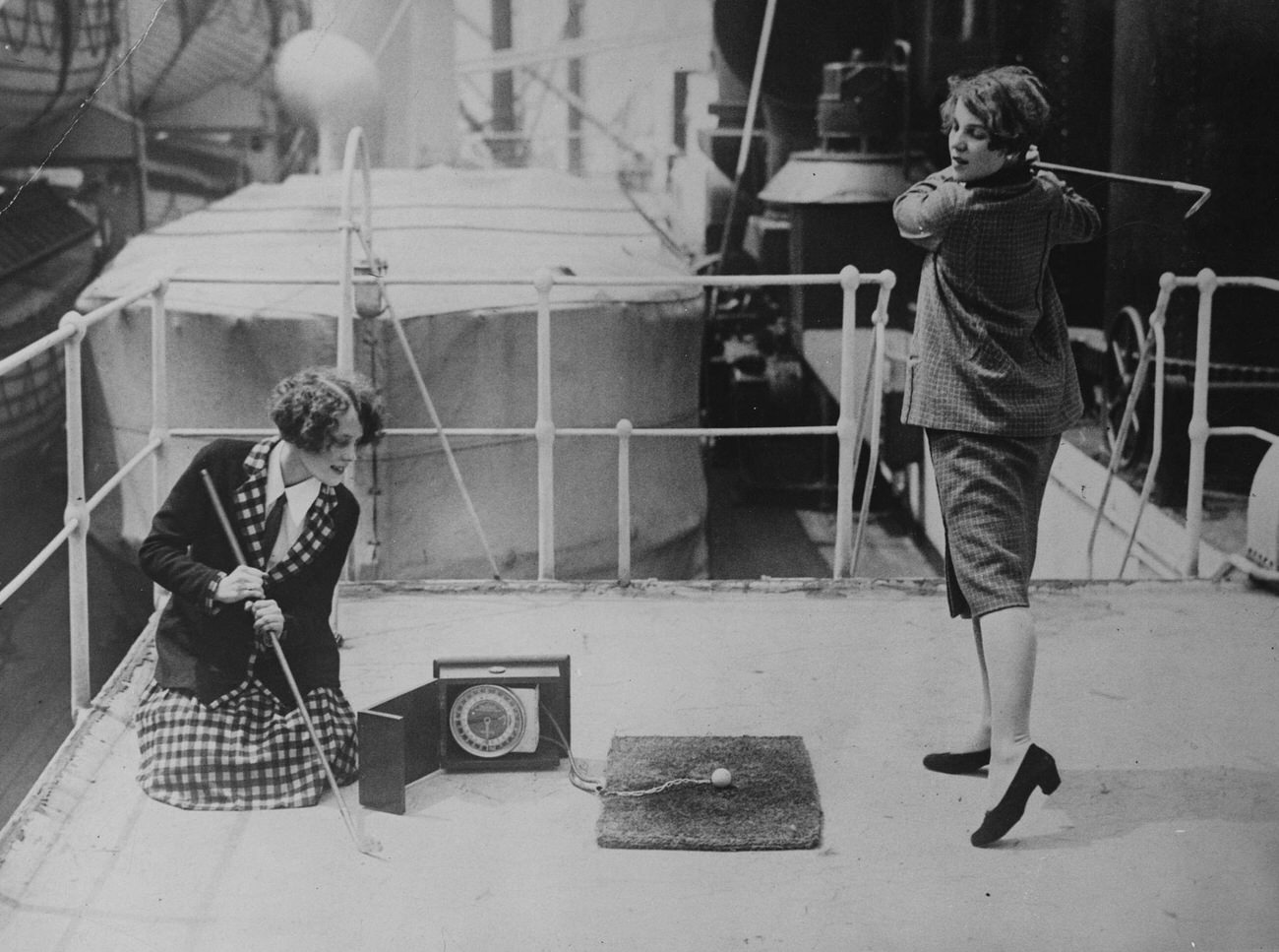 Women practicing golf on S.S. California ship deck.