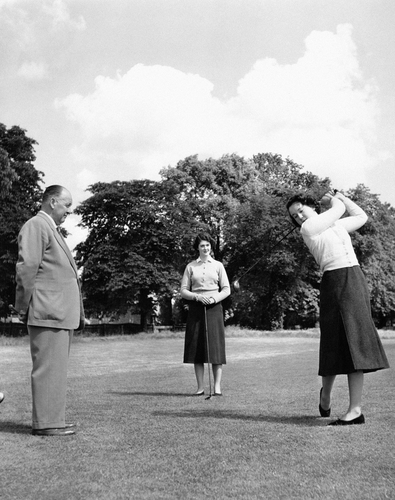 Young women learning golf at 'Cygnets House,' London, UK.