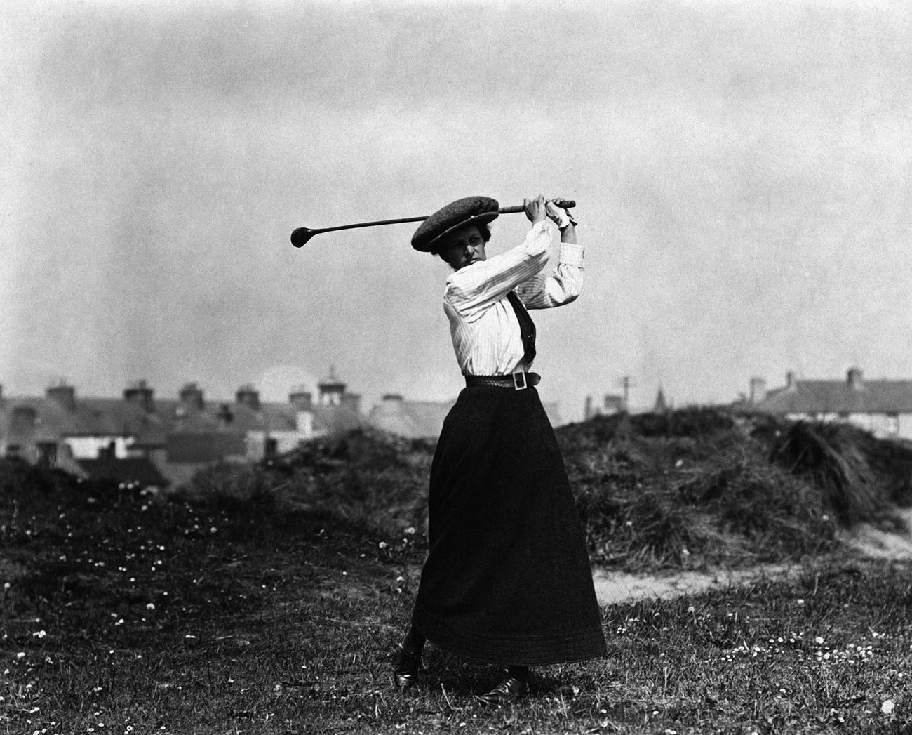Miss B. Thomson swinging golf club.