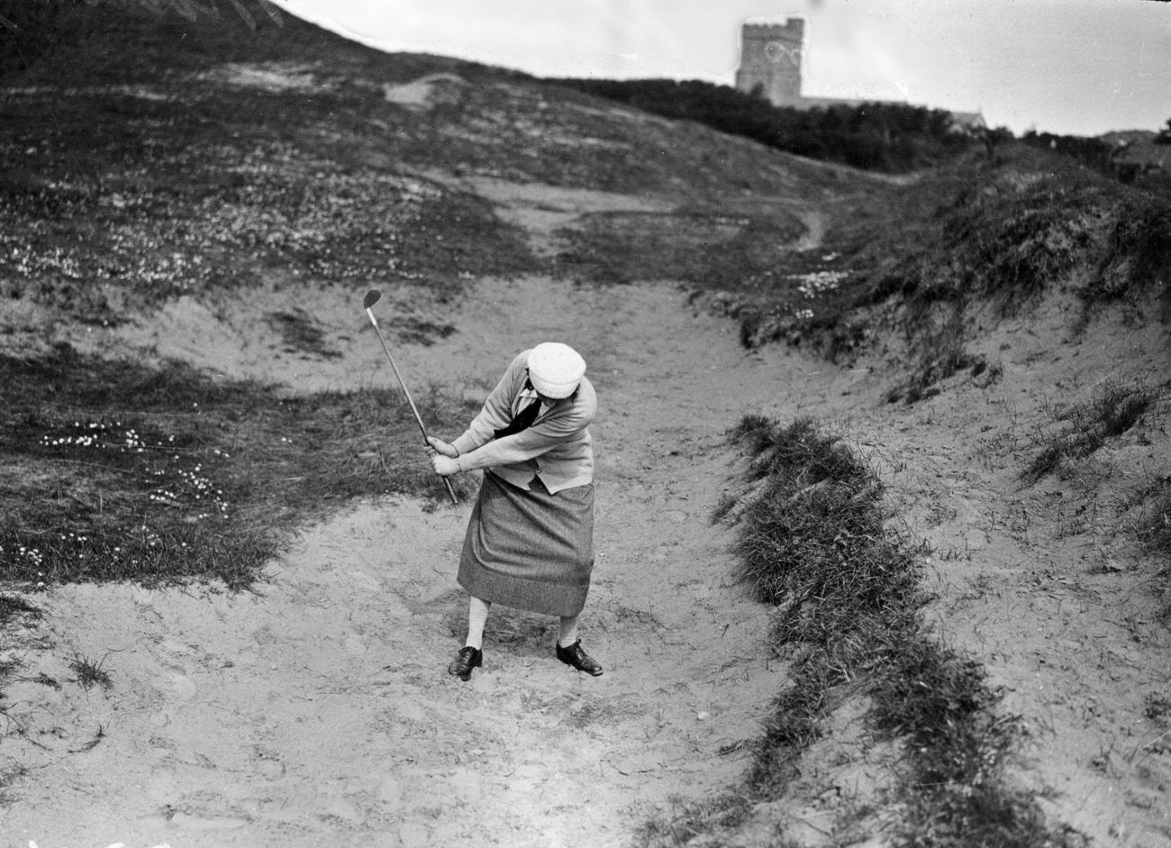 Mrs. Kenneth Morrice playing from bunker, Ladies Golf Championship, May 1923.