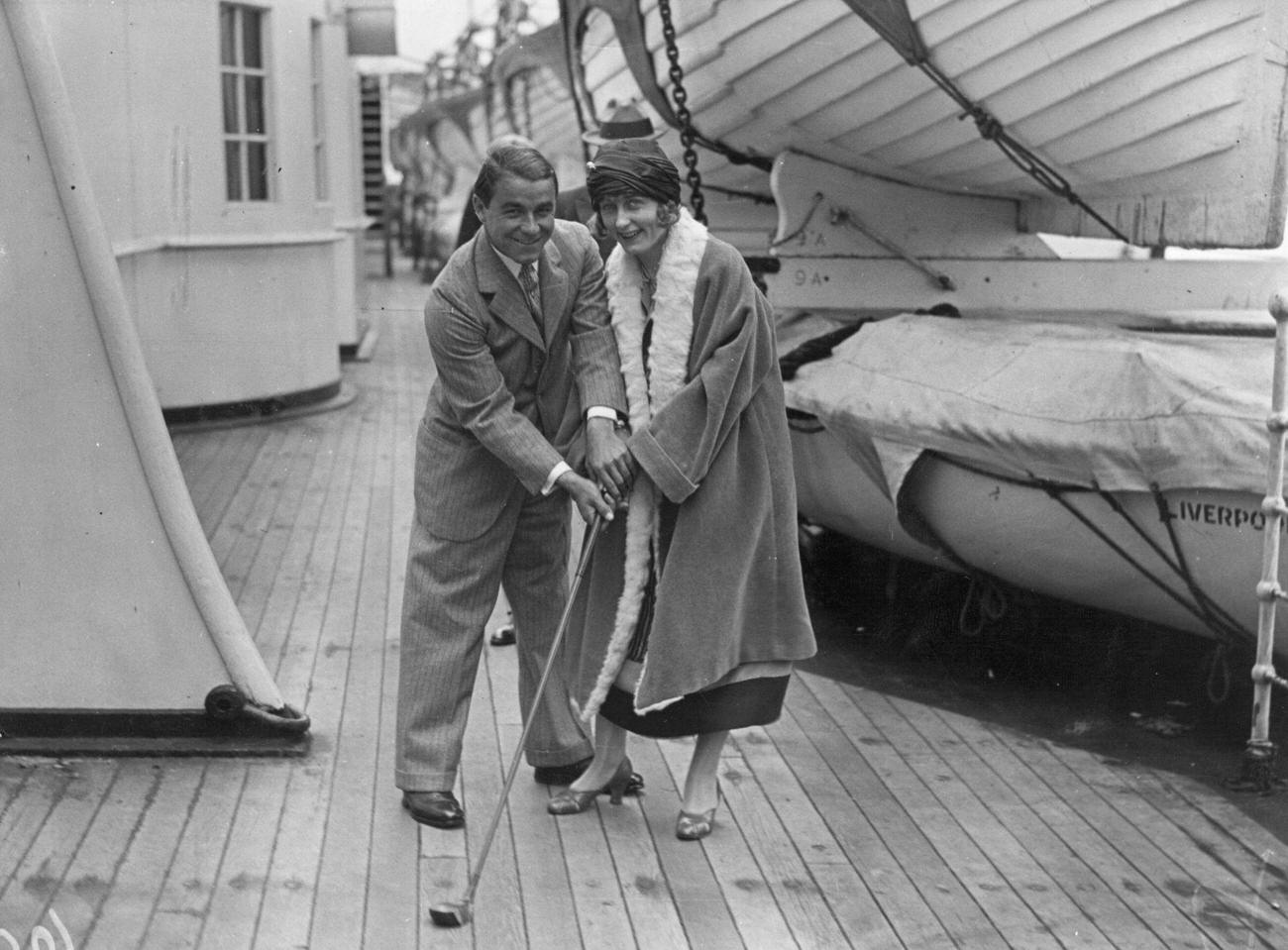 Gene Sarazen helping his wife practice golf, "Mauretania", June 1, 1924.