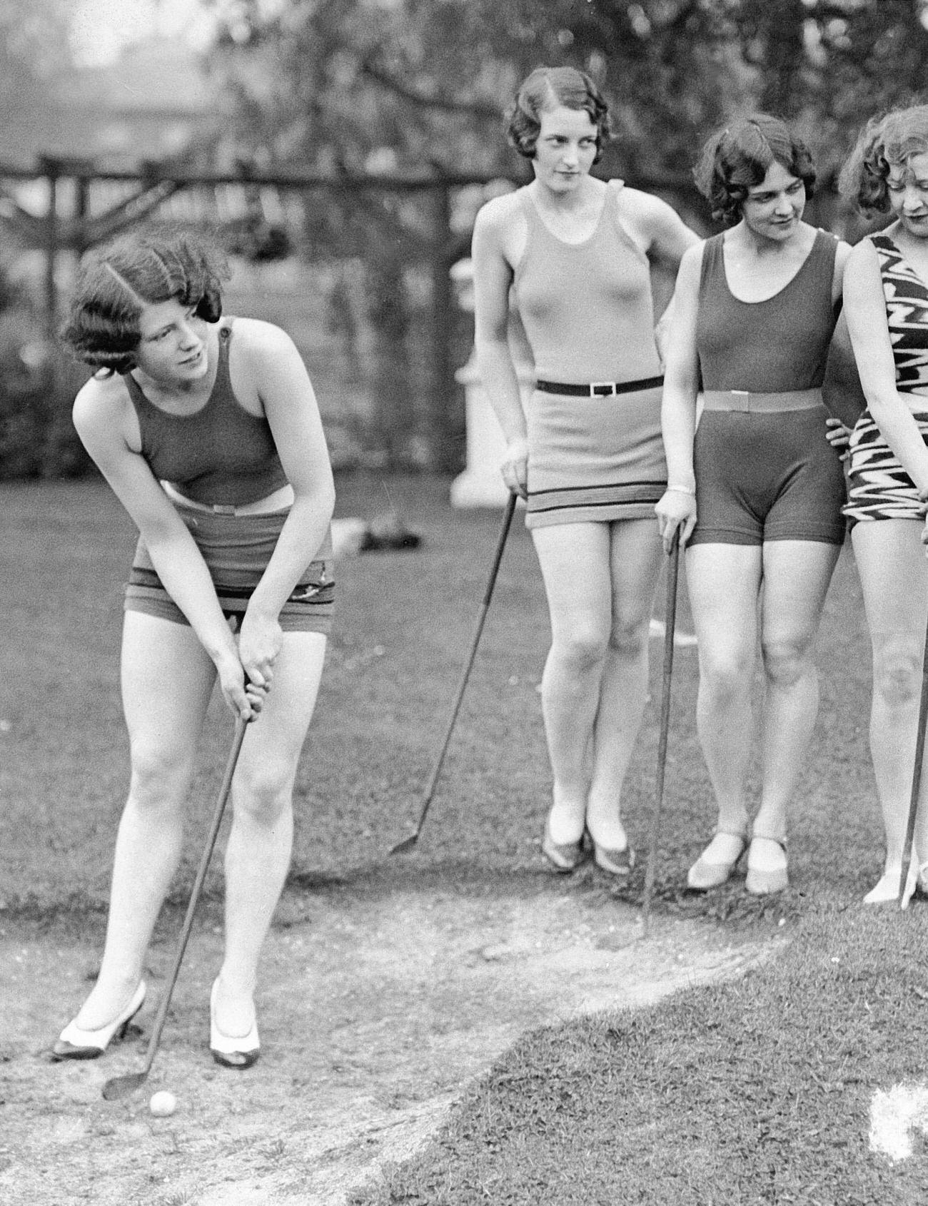 Showgirls playing golf in bathing suits, Wake up and Dream Revue, May 31, 1929, Maidenhead, London.