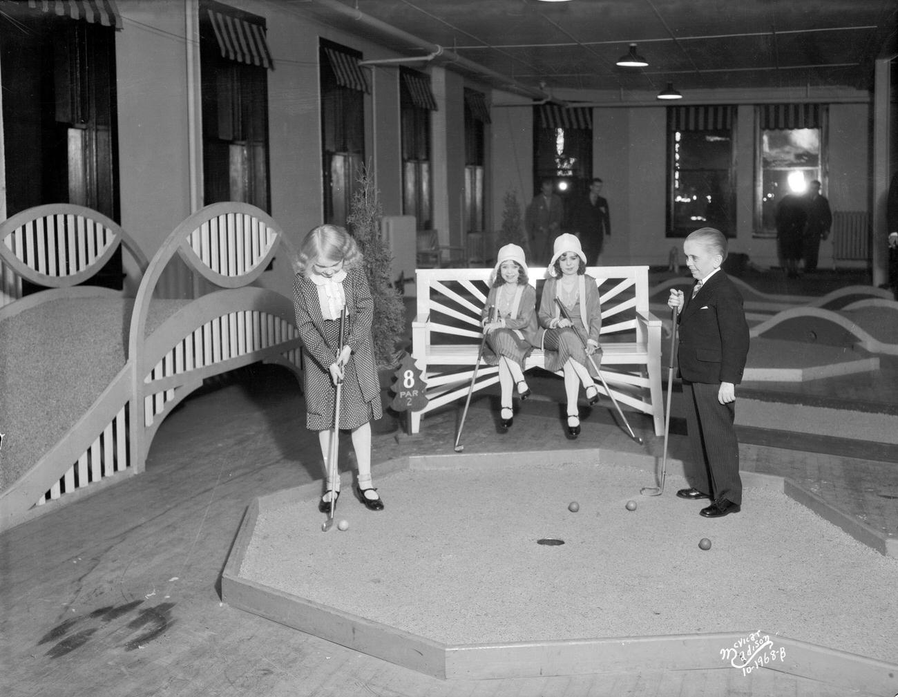 Dwarves playing miniature golf, Evergreen Miniature Golf Course, Madison, Wisconsin, November 2, 1930.