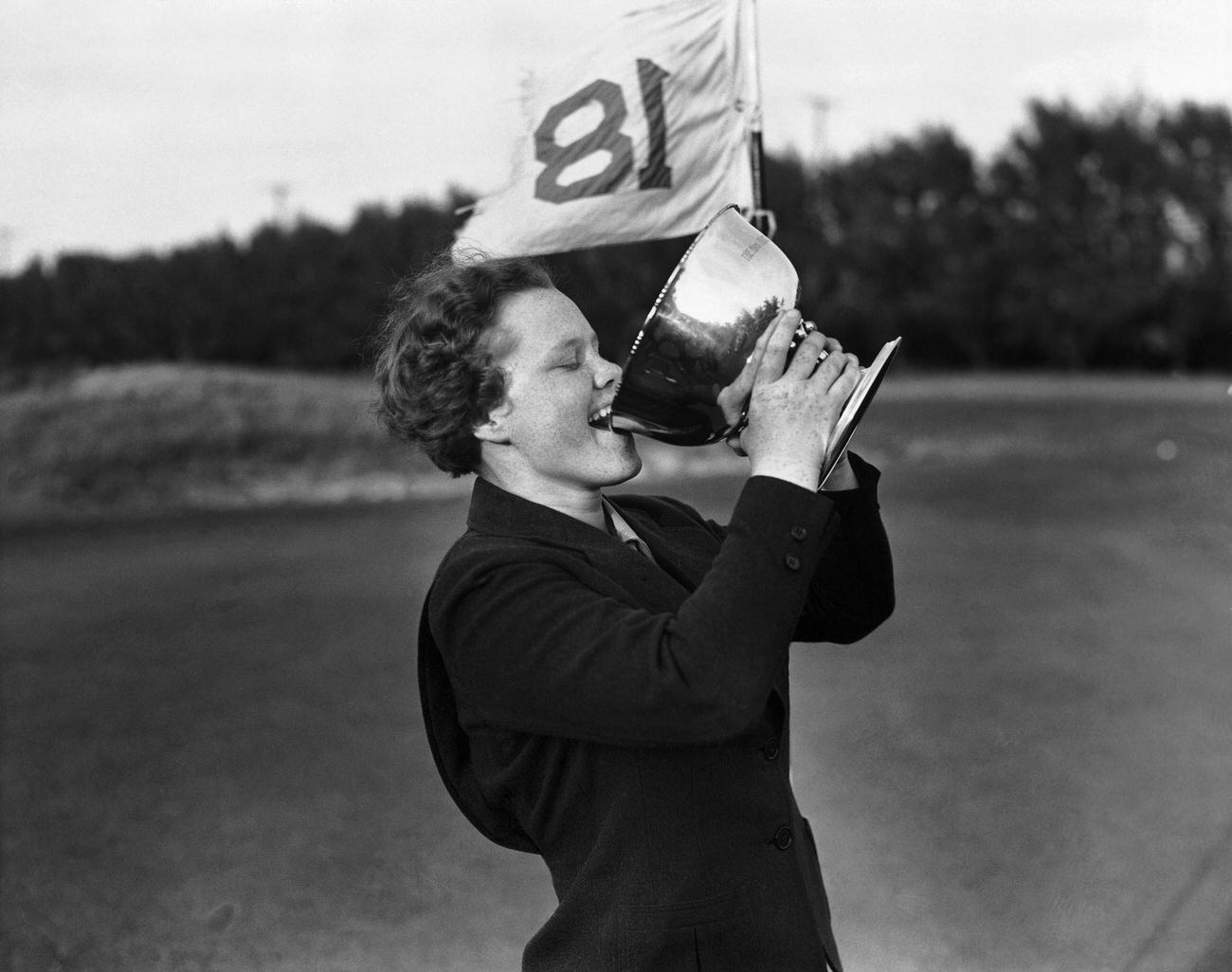 Patty Berg drinking from trophy at Palm Beach Women's Golf Championship.