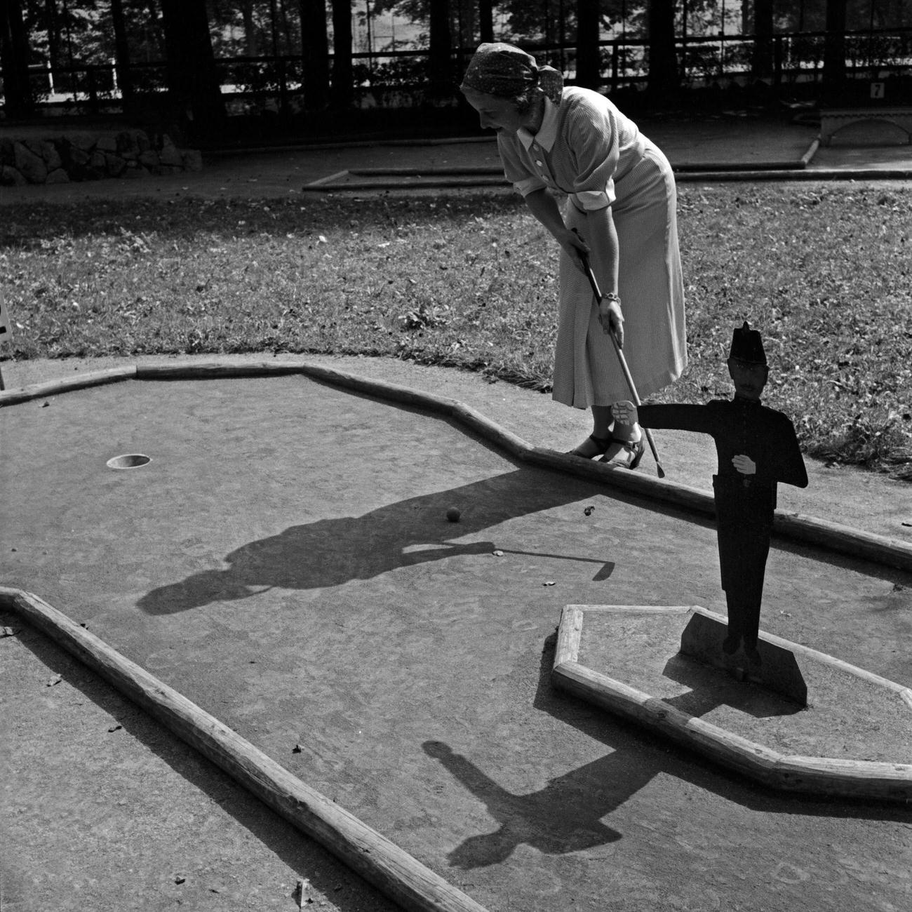 Woman playing crazy golf, Germany, 1930s.