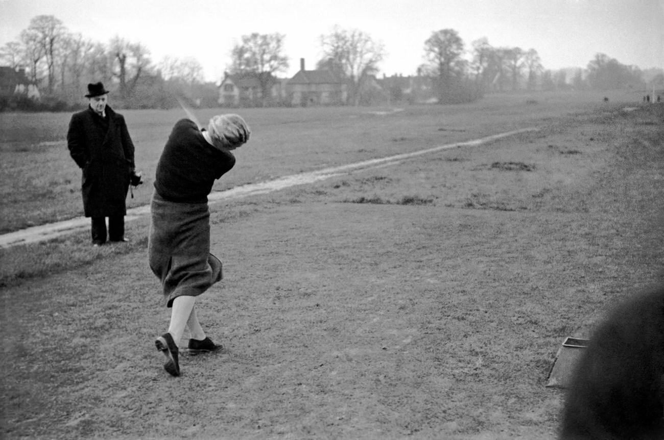 Woman playing golf, Jockey Gordon Richards' game, Romford, October 1937.