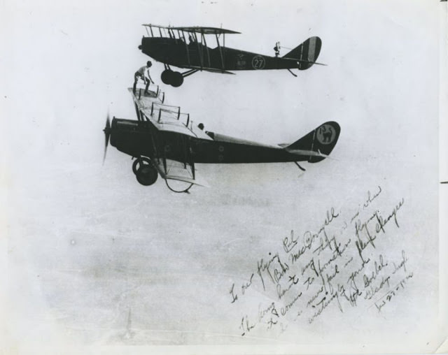 On this autographed photo of Gladys Gertrude Ingle (1899-1981) preparing to transfer from Bon MacDougall’s plane to Art Goebel's plane.