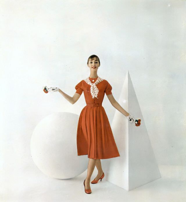 Dolores Hawkins in a red Enka rayon crêpe dress by Eloise Curtis, Vogue, February 1, 1958.
