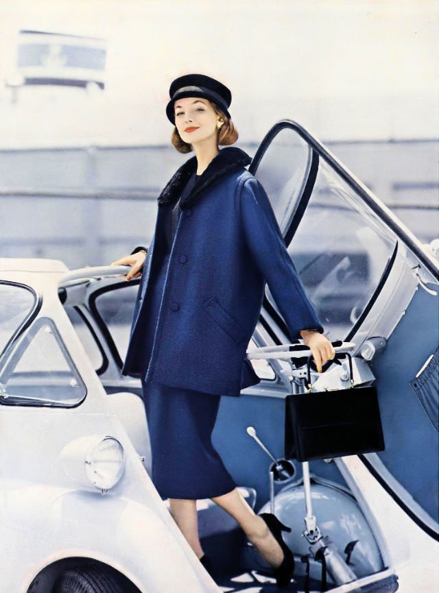 Dolores Hawkins in a blue-and-black herringbone wool skirt and jacket, Vogue, August 15, 1956.