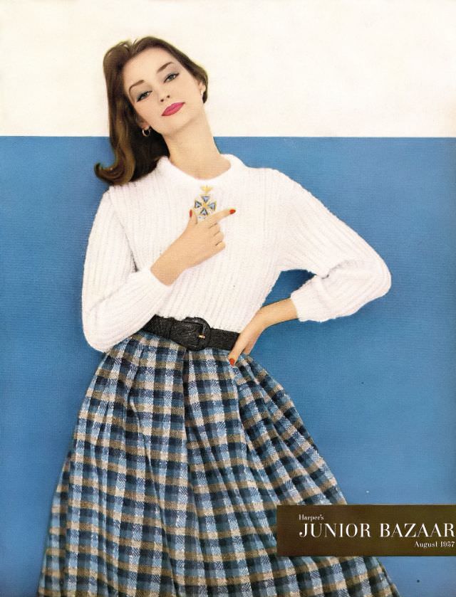 Dolores Hawkins in a white mohair and nylon sweater and plaid mohair and tweed skirt, Junior Bazaar, August 1957.