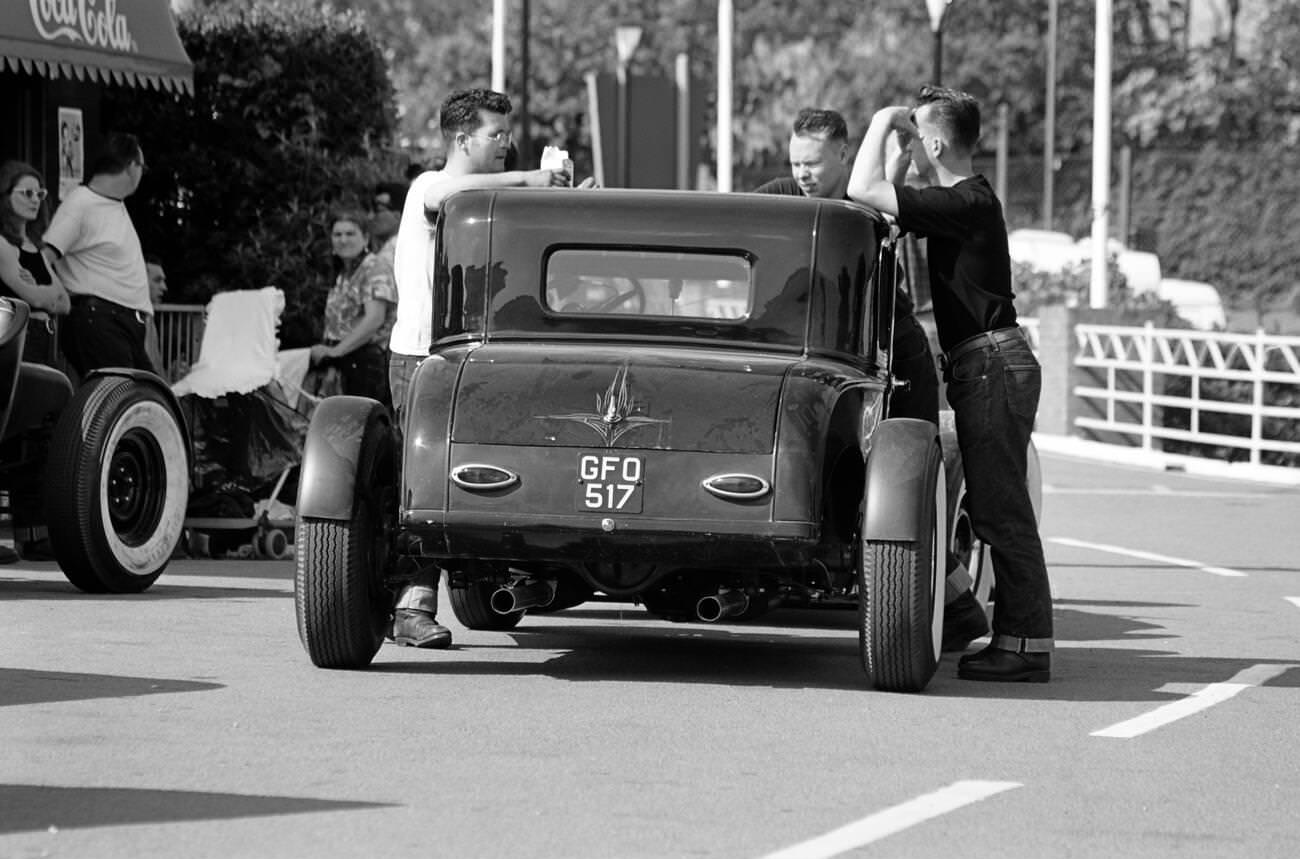 "Greasers" by their 1950s street rod at a rock 'n' roll retro festival.