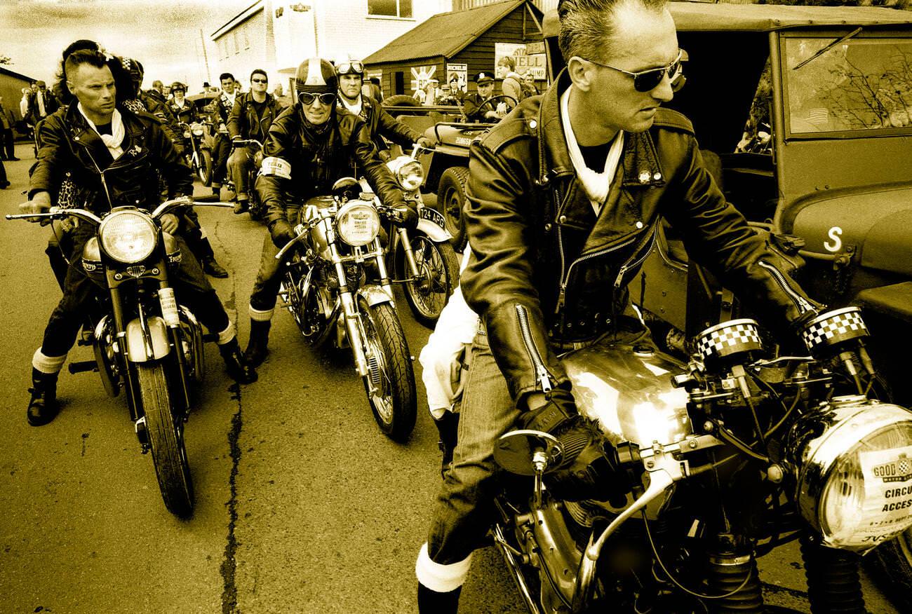 Greaser 1950s rockers on British classic BSA Norton motorcycles at Goodwood Revival.
