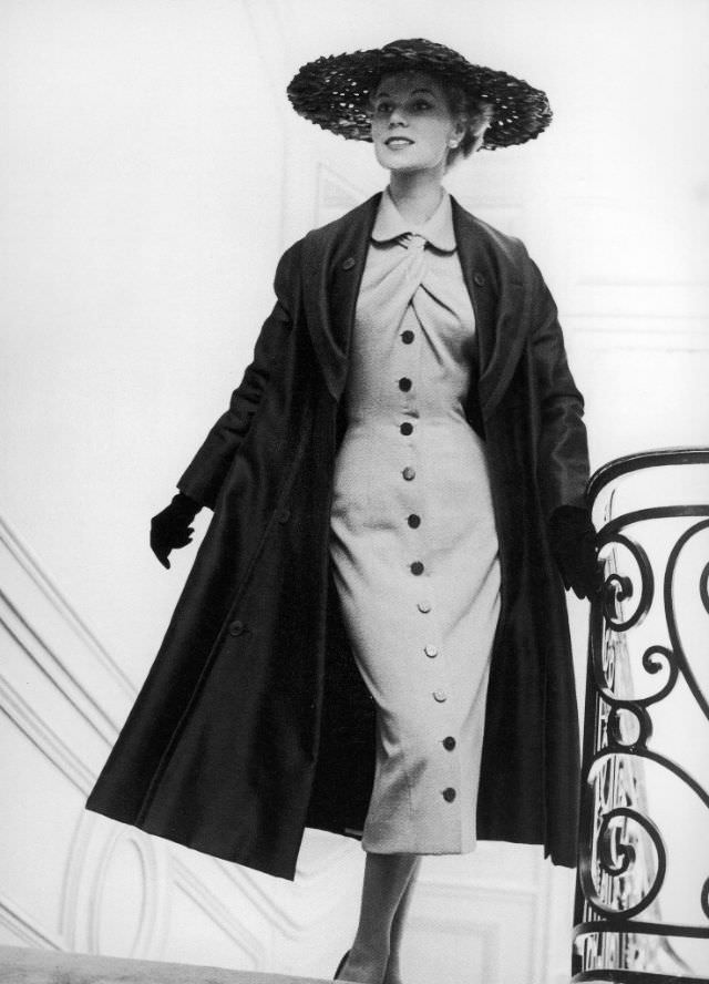 Stella in a grey jersey dress and silk taffeta coat by Jacques Fath, 1953.