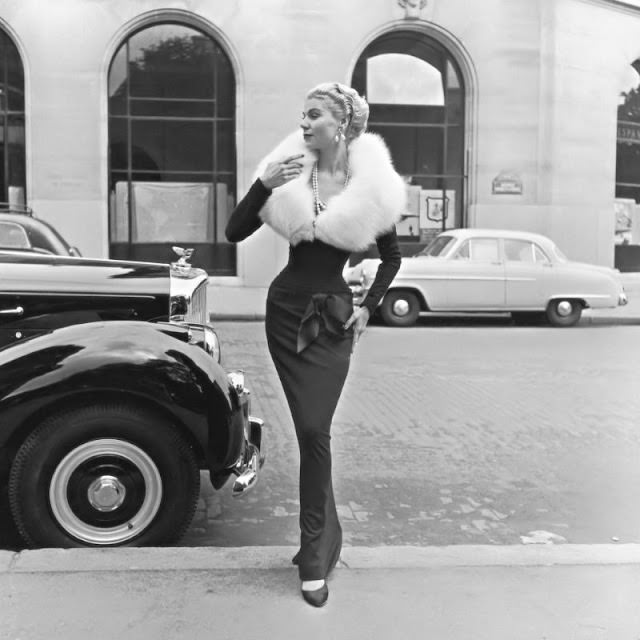 Stella in a slim-fitting evening dress with white fox fur collar by Jacques Fath, 1951.