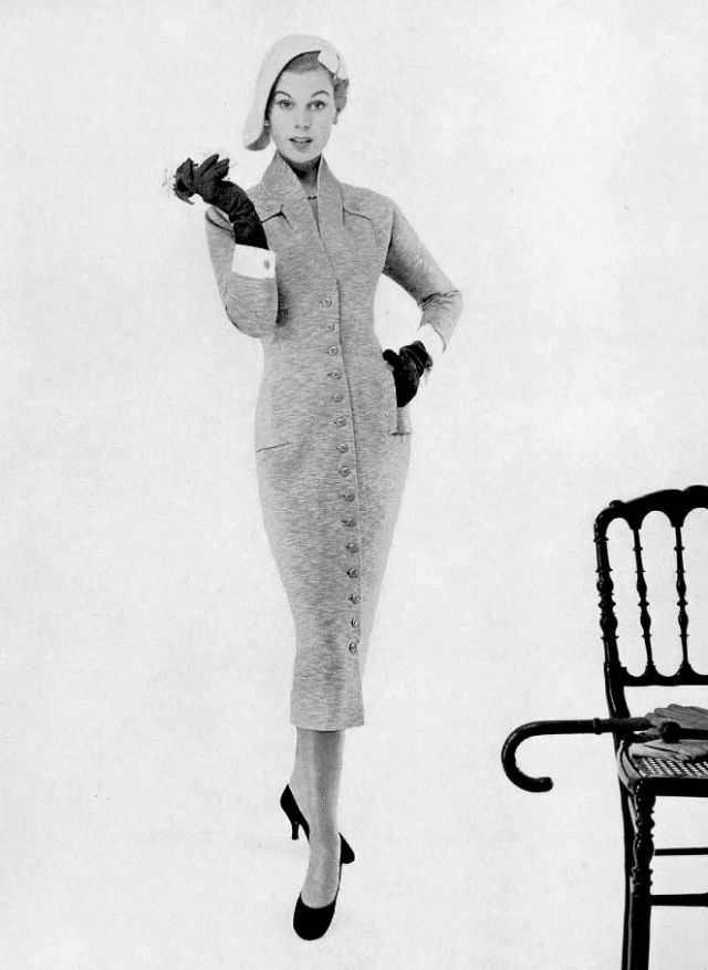 Stella in a front button-through jersey sheath by Jacques Fath, 1955.