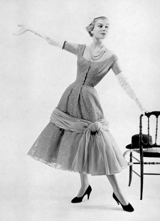 Stella in a lace cocktail dress by Jacques Fath, 1955.