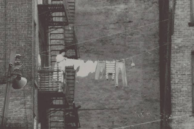 Woman hanging clothes on the line, November 1956