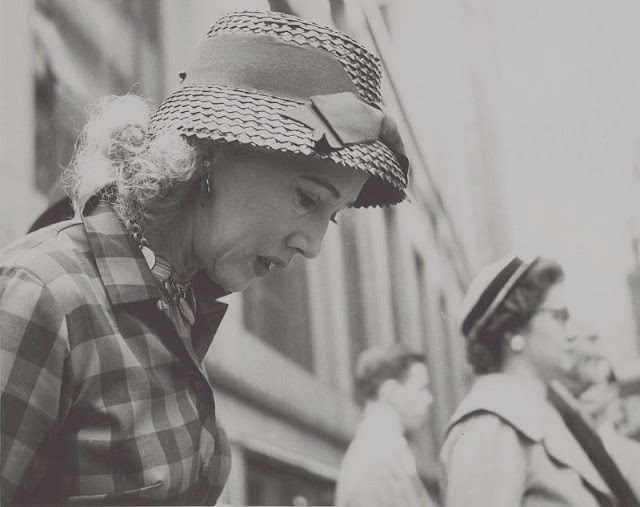 Woman, head-and-shoulders portrait, profile view, facing right and looking down, April 1959