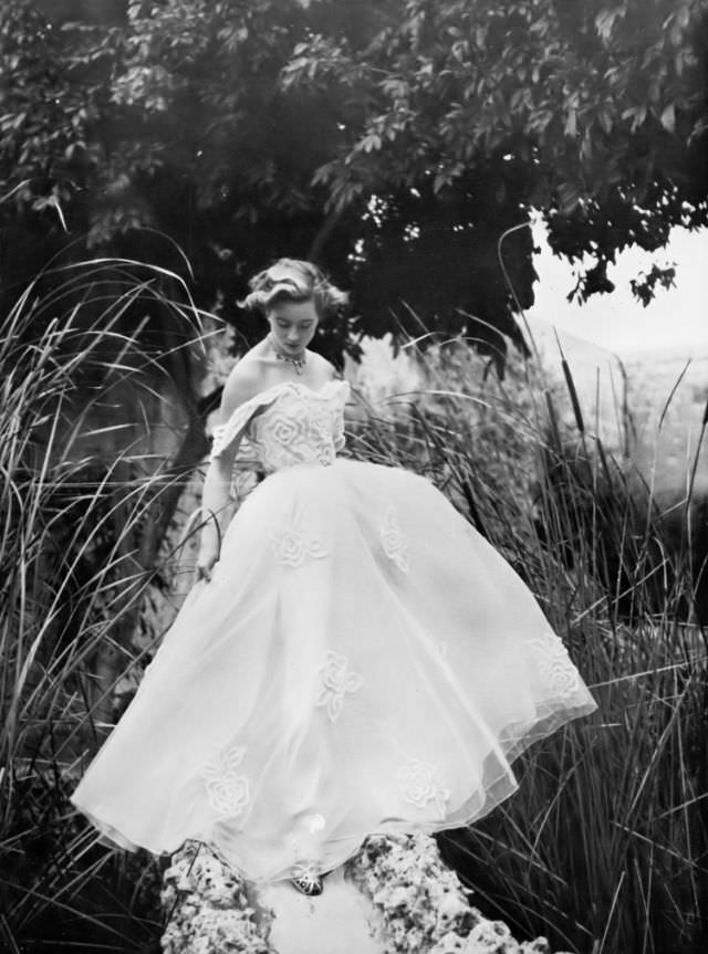 Pat O'Reilly in a white net dress by Roecliff & Chapman, Malta, Harper's Bazaar UK, May 1951.