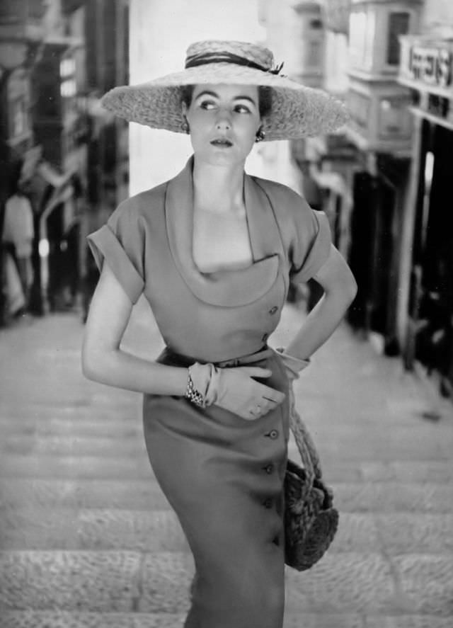 Pat O'Reilly in a tangerine shantung dress by Dorville, Malta, Harper's Bazaar UK, May 1951.