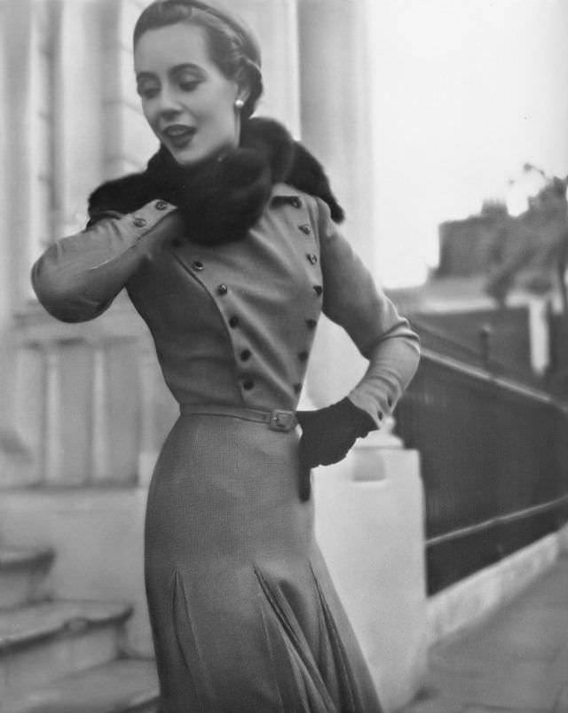 Pat O'Reilly in a high-neck dress in red, brown, and white tweed by Frederick Starke, Harper's Bazaar UK, August 1950.