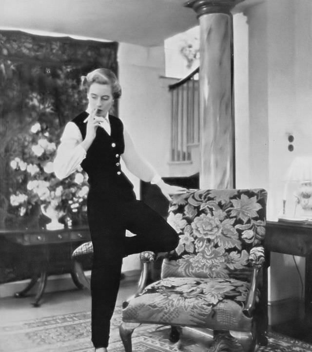 Pat O'Reilly in a black velveteen lounging suit by Londonus, Harper's Bazaar UK, October 1950.