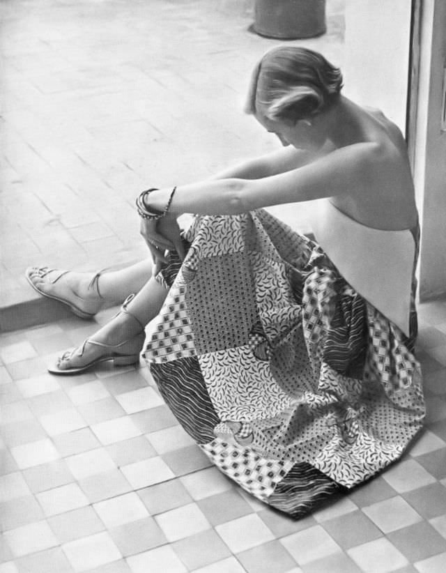 Pat O'Reilly in a blue and white patchwork sundress by Ian Meredith, Harper's Bazaar UK, June 1950.