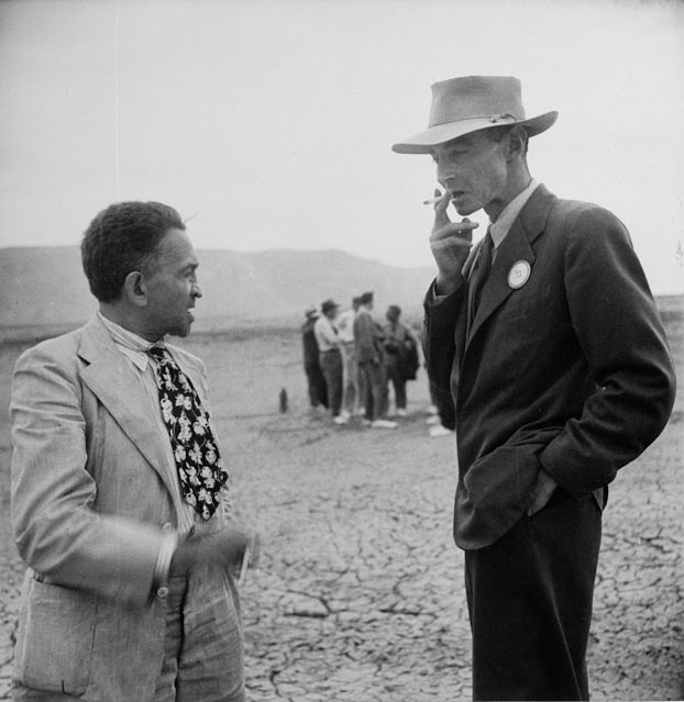 J. Robert Oppenheimer speaking with New York Times reporter William Laurence at the A-bomb blast site, 1945.