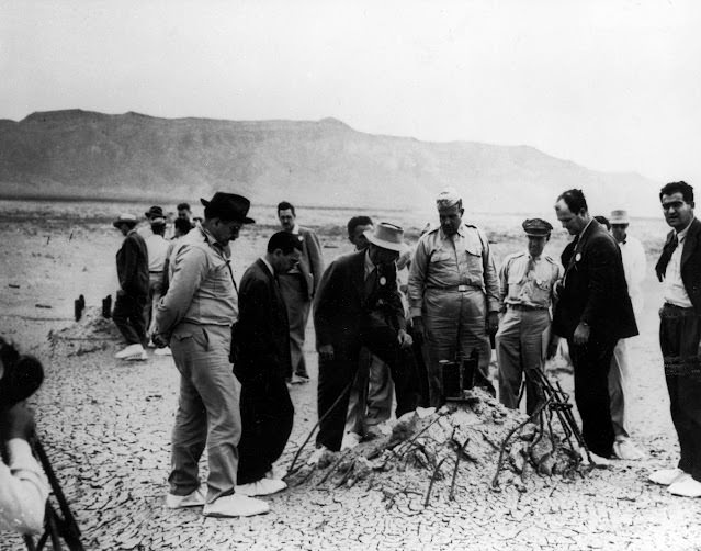 Manhattan Project officials, including Dr. Robert J. Oppenheimer and General Leslie Groves, at the Trinity atomic bomb test site, 1945.