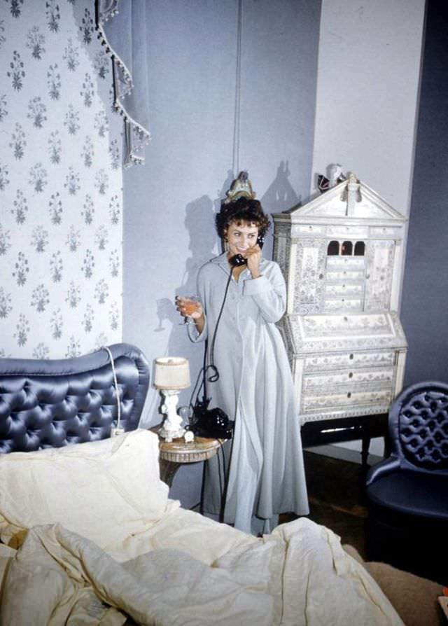 Sophia Loren talking on the phone in her Rome bedroom, 1957.