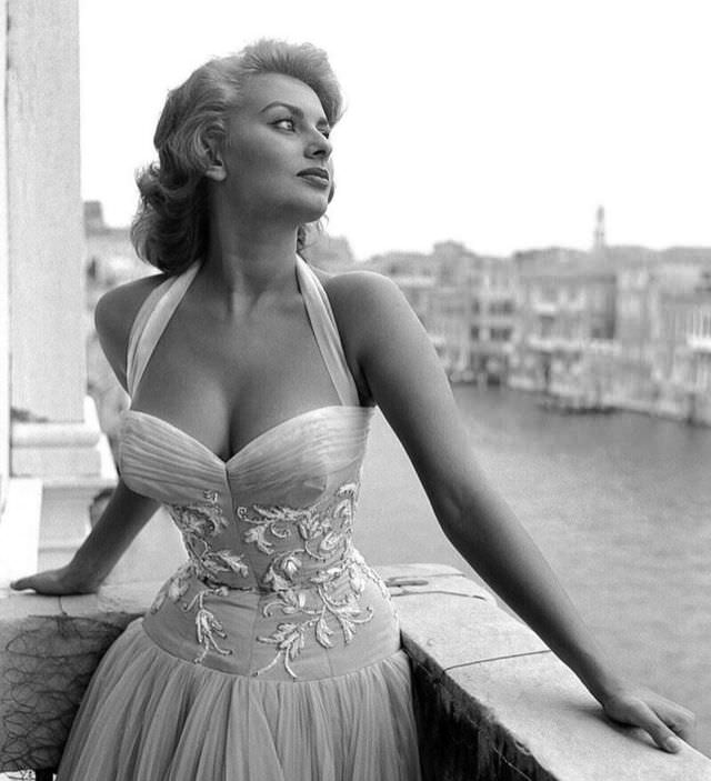 Sophia Loren in an embroidered dress on a balcony in Venice, 1955.