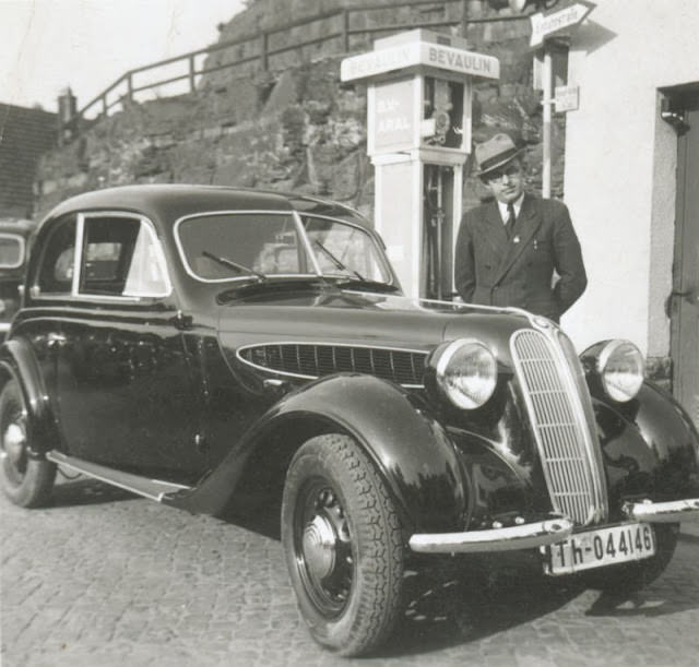 Man in pinstripe suit with a BMW 320 Limousine 2 Türen in Thuringia, circa 1930s.