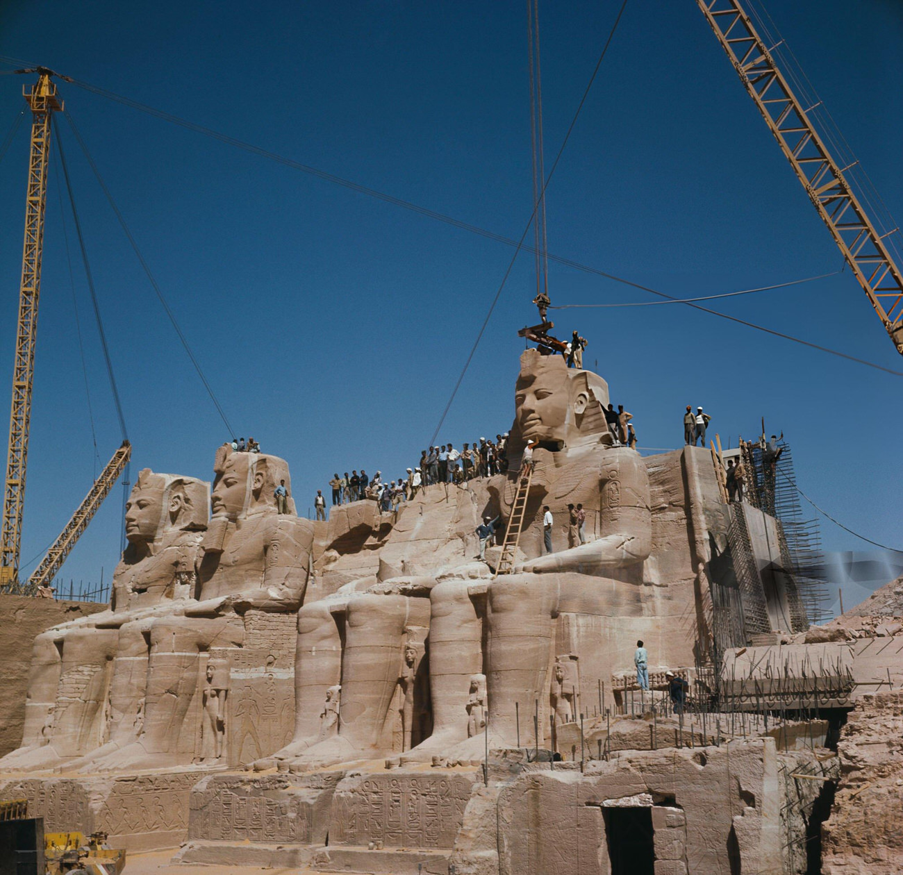 The disassembly of Pharaoh Ramesses II's statues at Abu Simbel in 1964 for relocation to avoid Nile flooding from the Aswan High Dam.