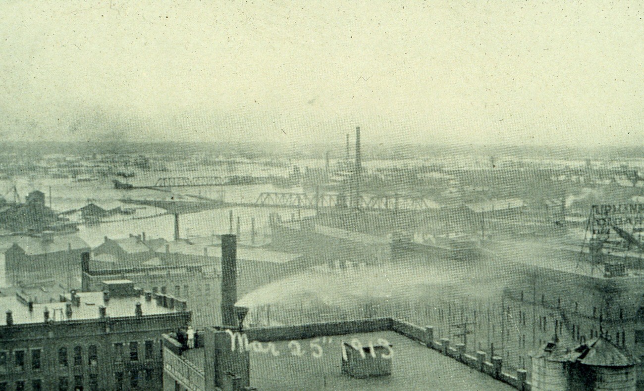 Aerial view of the 1913 flood in Columbus, featuring the Charles C. Higgins Wholesale Grocery Building, March 25, 1913.