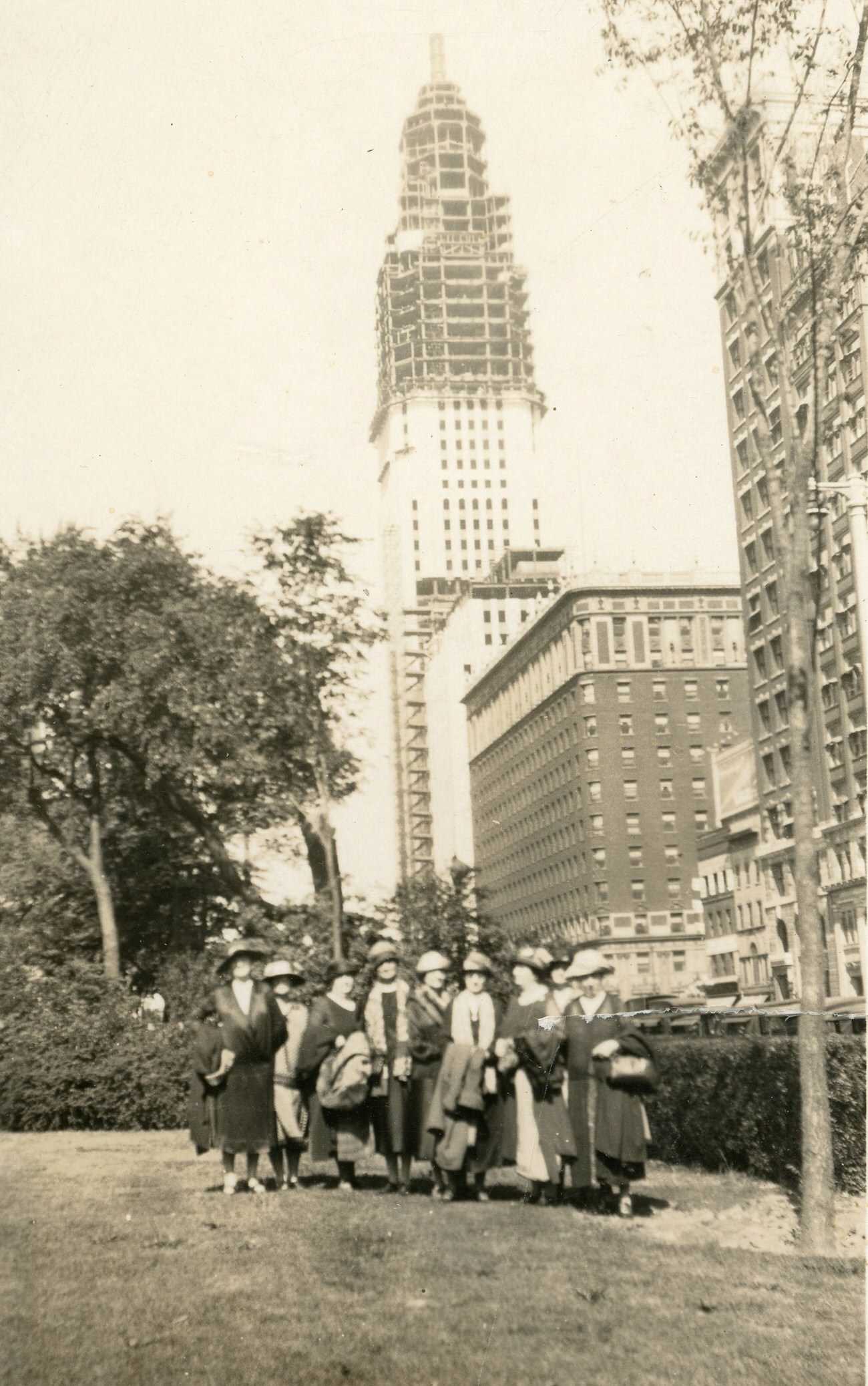 Group of women at Ohio Statehouse with the AIU Citadel under construction in the background, 1924